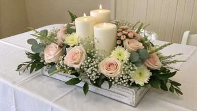 Elegant and simple baby shower centerpiece with flowers and candles for boys or girls, perfect for 2025 celebrations.
