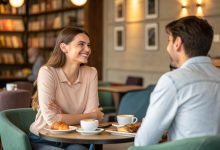 Confident woman starting a conversation with a guy at a coffee shop—open posture, warm smile, relaxed body language