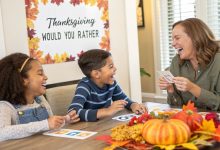 Family laughing while playing Thanksgiving Would You Rather game with printable cards