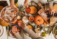 friendsgiving theme ideas table setup with cozy fall decorations and friends laughing