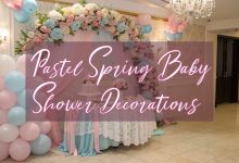 Pastel spring baby shower decorations with floral backdrop, balloon arch, and elegant baby shower table setup